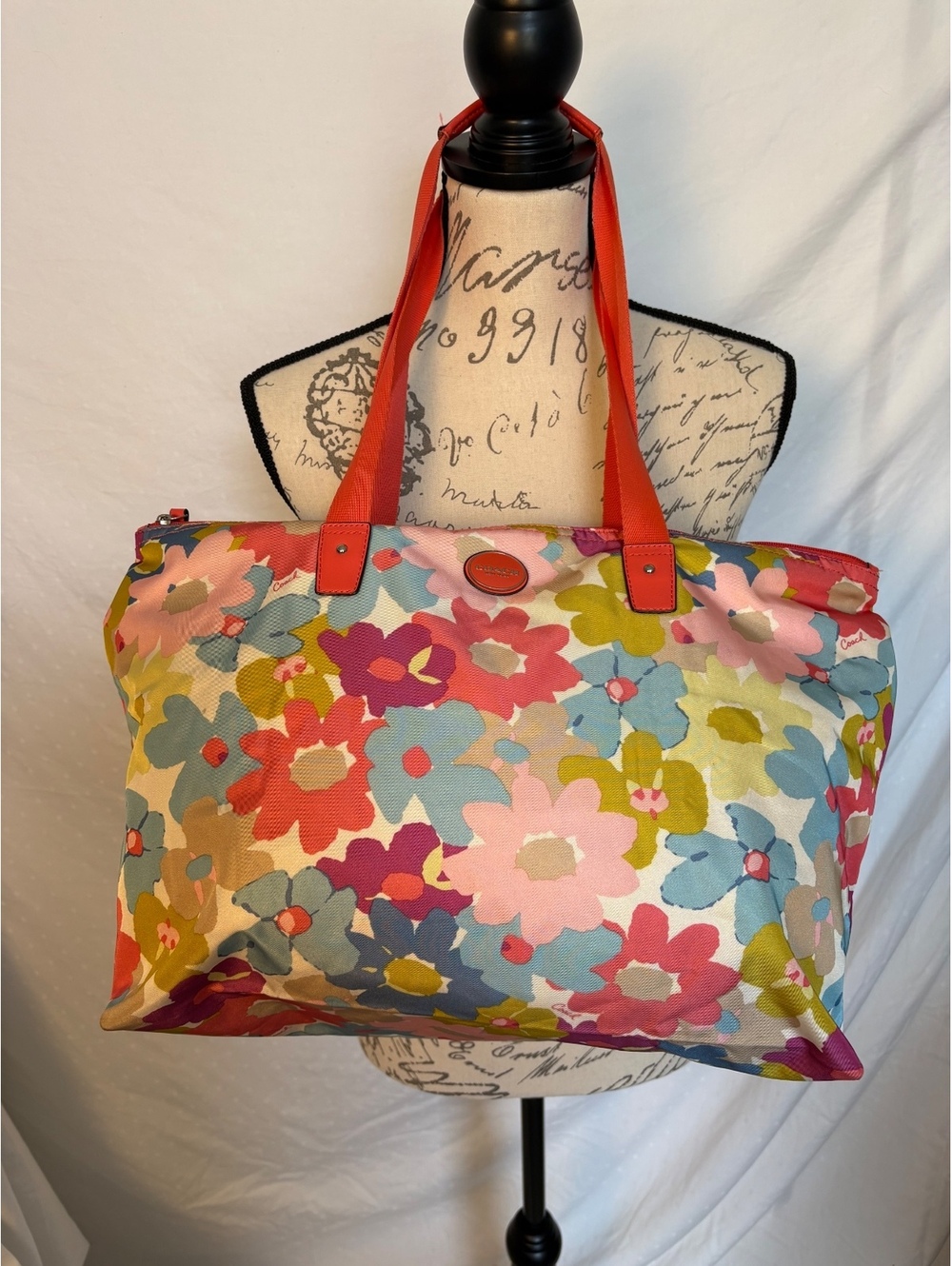 Bright and cheerful Coach tote featuring an oversized multicolor floral print.